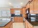 Kitchen with granite counters, stainless steel appliances, and ample wood cabinets at 786 Seneca Meadows Rd, Winter Springs, FL 32708