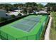 Well-maintained community tennis court with a green surface and surrounding greenery for recreational play at 786 Seneca Meadows Rd, Winter Springs, FL 32708