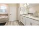 Bathroom featuring double sinks, granite counters, and a tub for a luxurious bathing experience at 9036 Stinger E Dr, Davenport, FL 33896