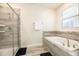 Bright bathroom featuring glass shower and a large tub for a luxurious bathing experience at 9036 Stinger E Dr, Davenport, FL 33896