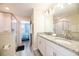 Bright bathroom featuring double sinks with granite countertops, a glass-enclosed shower, and modern fixtures at 9036 Stinger E Dr, Davenport, FL 33896