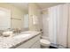 Bathroom featuring granite countertop, single sink, toilet, and shower with curtain at 9036 Stinger E Dr, Davenport, FL 33896