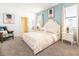 Inviting bedroom with carpet flooring, soft blue walls, and a comfortable queen-sized bed at 9036 Stinger E Dr, Davenport, FL 33896