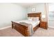 Comfortable bedroom with a wooden bed, carpet flooring, and soothing wall color at 9036 Stinger E Dr, Davenport, FL 33896