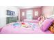 A fun bedroom with themed beds, a TV, and flamingo artwork on the walls at 9036 Stinger E Dr, Davenport, FL 33896
