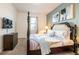 Bedroom with a four-poster bed, neutral carpeting, and walls accented with modern artwork at 9036 Stinger E Dr, Davenport, FL 33896