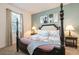 Comfortable bedroom with a four-poster bed, soft linens, and a window with natural light at 9036 Stinger E Dr, Davenport, FL 33896