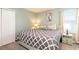 Comfortable bedroom with a full bed and decorative touches, illuminated by soft lamps at 9036 Stinger E Dr, Davenport, FL 33896
