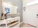 Welcoming entryway featuring a console table with decorative items and a large mirror at 9036 Stinger E Dr, Davenport, FL 33896