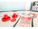 Close-up of a red air hockey puck and paddles on a table in the game room at 9036 Stinger E Dr, Davenport, FL 33896