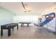 Spacious garage with entertainment: a basketball game, foosball, and pool table at 9036 Stinger E Dr, Davenport, FL 33896
