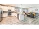 Open-concept kitchen with stainless steel appliances, granite countertops, and an island at 9036 Stinger E Dr, Davenport, FL 33896