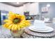 Bright kitchen showcasing granite counters, modern fixtures and sunflower center piece at 9036 Stinger E Dr, Davenport, FL 33896