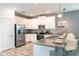 Well-equipped kitchen featuring stainless steel appliances, granite countertops, and ample white cabinetry at 9036 Stinger E Dr, Davenport, FL 33896