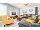 Cozy living room with a comfortable sectional sofa, a wooden coffee table, and a ceiling fan at 9036 Stinger E Dr, Davenport, FL 33896