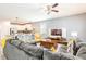 Open-concept living area with modern furnishings and a view of the kitchen and dining area at 9036 Stinger E Dr, Davenport, FL 33896