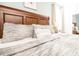 Spacious main bedroom with soft, neutral bedding and ample natural light at 9036 Stinger E Dr, Davenport, FL 33896