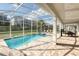 Relaxing pool area featuring a covered patio, spa, and sun loungers, perfect for outdoor enjoyment at 9036 Stinger E Dr, Davenport, FL 33896
