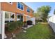 Backyard featuring privacy fence, green grass, patio, awning, and outdoor seating at 9535 Silver Buttonwood St, Orlando, FL 32832
