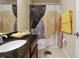 Bathroom with a granite countertop vanity, decorative shower curtain, and neutral tile flooring at 9535 Silver Buttonwood St, Orlando, FL 32832