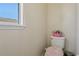 Cozy half bathroom featuring a toilet and a window that brightens the space at 9535 Silver Buttonwood St, Orlando, FL 32832