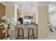 Cozy breakfast bar area with pendant lighting and views into the kitchen and dining space at 9535 Silver Buttonwood St, Orlando, FL 32832