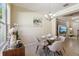 Bright dining area with a modern chandelier and a view of the living room with a TV at 9535 Silver Buttonwood St, Orlando, FL 32832