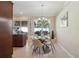 Bright dining area with a round table set, chandelier, and natural light from the adjacent window at 9535 Silver Buttonwood St, Orlando, FL 32832