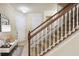 Inviting entryway with a staircase, white door, and a cozy seating area at 9535 Silver Buttonwood St, Orlando, FL 32832