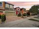 Colorful townhomes featuring brick driveways and well-maintained landscaping at 9535 Silver Buttonwood St, Orlando, FL 32832