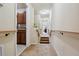 Hallway with carpet and railings, leading to the kitchen and other rooms at 9535 Silver Buttonwood St, Orlando, FL 32832