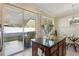 Kitchen island with granite countertop, bar stools, and a view of the dining area and patio at 9535 Silver Buttonwood St, Orlando, FL 32832