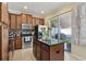 Well-equipped kitchen with stainless steel appliances, granite countertops, and an island at 9535 Silver Buttonwood St, Orlando, FL 32832