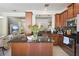 Open concept kitchen with stainless steel appliances, granite countertops, and an island at 9535 Silver Buttonwood St, Orlando, FL 32832