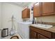 Functional laundry room with washer, dryer, cabinets, and a sink for convenience at 9535 Silver Buttonwood St, Orlando, FL 32832