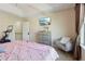 Relaxing main bedroom with a large window, television, and a seating chair at 9535 Silver Buttonwood St, Orlando, FL 32832