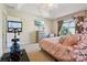 Comfortable main bedroom with large window, a TV, and exercise equipment at 9535 Silver Buttonwood St, Orlando, FL 32832