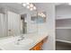 Bright bathroom featuring a single sink vanity, and a well-lit mirror and light fixture at 1048 Lake Berkley Dr, Kissimmee, FL 34746