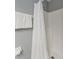 Bathroom with a white shower curtain, shower head, towel bar and a roll of toilet paper at 1048 Lake Berkley Dr, Kissimmee, FL 34746