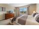 Bright bedroom with large window and soft carpet and a queen-sized bed at 1048 Lake Berkley Dr, Kissimmee, FL 34746