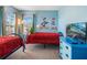 Blue bedroom featuring twin beds with Disney-themed decor and a television at 1048 Lake Berkley Dr, Kissimmee, FL 34746