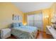 Bright bedroom featuring hardwood floors, a window, and blue accents at 1048 Lake Berkley Dr, Kissimmee, FL 34746