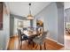 Formal dining area featuring hardwood floors, a chandelier, and access to the kitchen at 1048 Lake Berkley Dr, Kissimmee, FL 34746