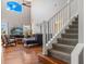 Bright, open-concept living room with hardwood floors, vaulted ceiling, and staircase at 1048 Lake Berkley Dr, Kissimmee, FL 34746