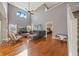 Comfortable living room with hardwood floors, high ceilings, and view into the main bedroom and staircase at 1048 Lake Berkley Dr, Kissimmee, FL 34746