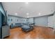 Spacious living room with hardwood floors, a comfortable sectional, and a wall decorated with framed prints at 1048 Lake Berkley Dr, Kissimmee, FL 34746