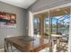 Covered screened-in patio overlooking a lake with outdoor seating and a ceiling fan at 1048 Lake Berkley Dr, Kissimmee, FL 34746