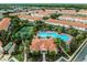 Beautiful aerial view of a resort community with a pool, tennis court, and clubhouse at 1149 S Beach Cir, Kissimmee, FL 34746