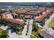 Stunning aerial view of a vibrant community, showcasing lush landscaping, a sparkling pool, and terracotta rooftops at 1149 S Beach Cir, Kissimmee, FL 34746