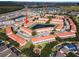 A beautiful aerial view of townhomes surrounding a pond in a well-maintained community with mature trees and landscaping at 1149 S Beach Cir, Kissimmee, FL 34746